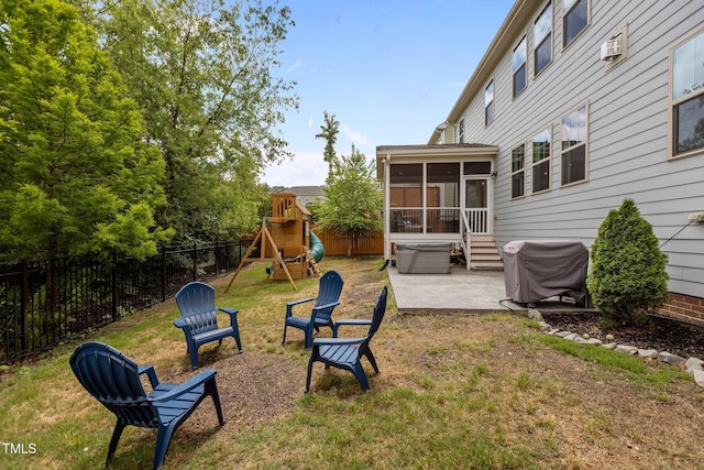 view of yard with a sunroom, a patio, a playground, and a wall unit AC