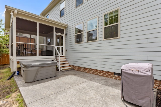 view of patio featuring a sunroom and a grill