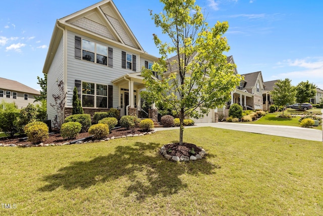 craftsman-style home with driveway, a front lawn, and brick siding