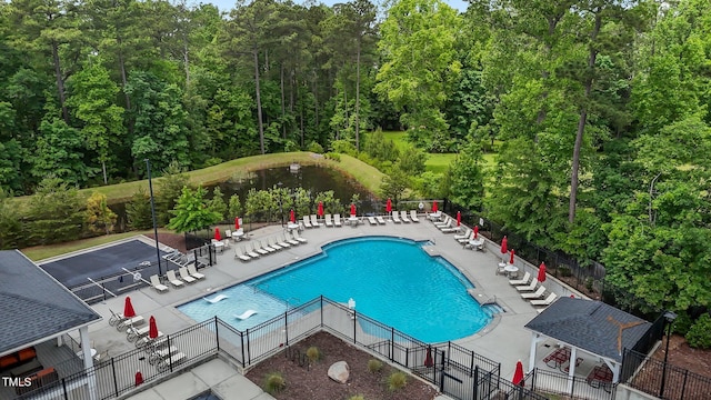 community pool featuring fence and a patio area