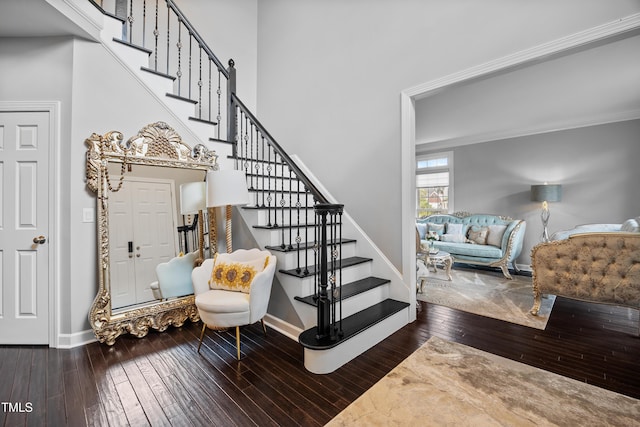 stairway with hardwood / wood-style floors and baseboards