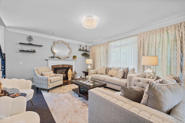 living area with ornamental molding, dark wood-style flooring, a fireplace, and baseboards