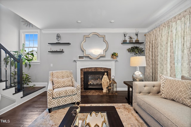 living area featuring stairs, hardwood / wood-style floors, baseboards, and crown molding