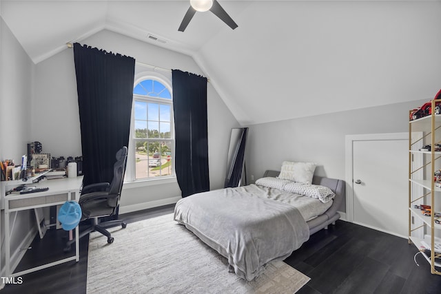 bedroom with lofted ceiling, a desk, wood finished floors, and ceiling fan
