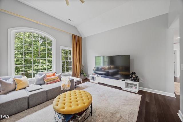 living room with dark wood-type flooring, lofted ceiling, ceiling fan, and baseboards