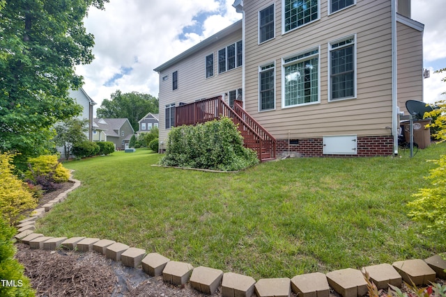rear view of house with a lawn, crawl space, and stairway
