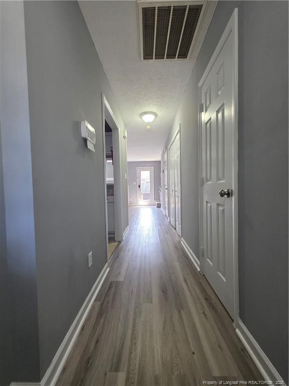 2604 Burke Ln, Fayetteville, NC 28306 - hallway with wood finished floors, baseboards, and a textured ceiling