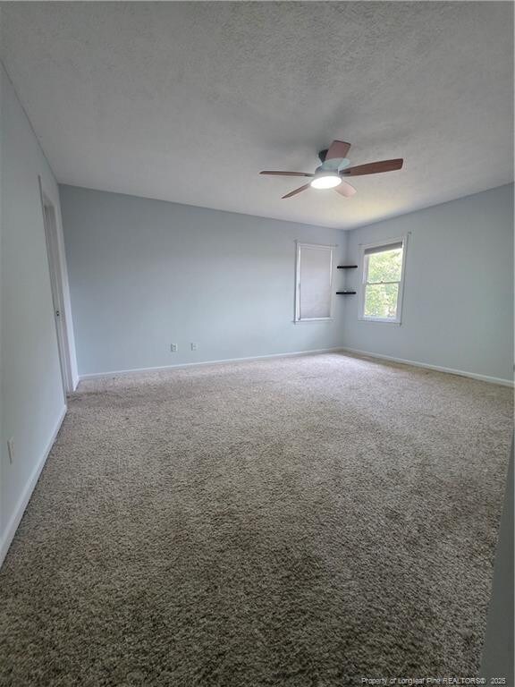 2604 Burke Ln, Fayetteville, NC 28306 - carpeted spare room with baseboards, ceiling fan, and a textured ceiling
