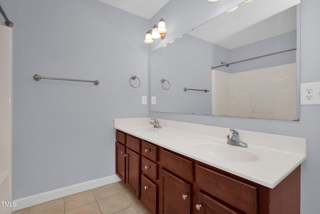 full bathroom with baseboards, tile patterned flooring, and double vanity