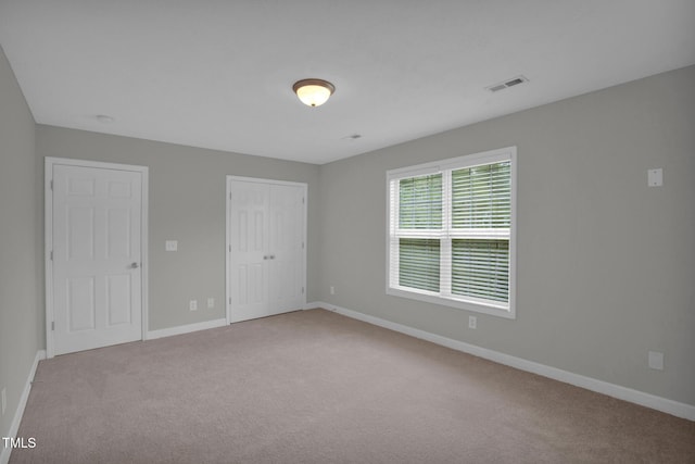 unfurnished bedroom with baseboards, carpet floors, and a closet