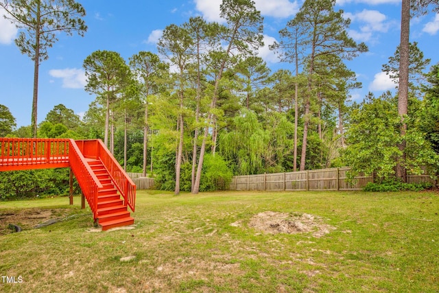 view of yard with stairway and a wooden deck