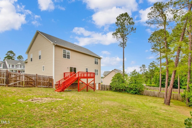 rear view of property featuring stairway and a wooden deck