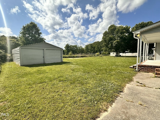 view of green lawn featuring a shed and an outbuilding