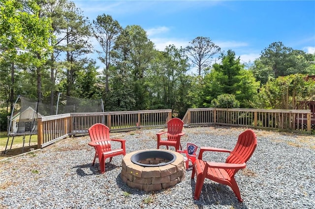 4725 Grandison Ct, Hope Mills, NC 28348 - view of patio / terrace with a trampoline, a fire pit, and view of wooded area