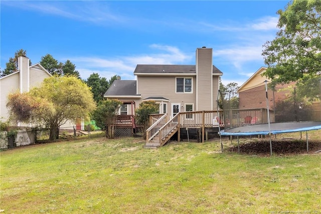 4725 Grandison Ct, Hope Mills, NC 28348 - back of house featuring a trampoline, a wooden deck, a chimney, and stairway
