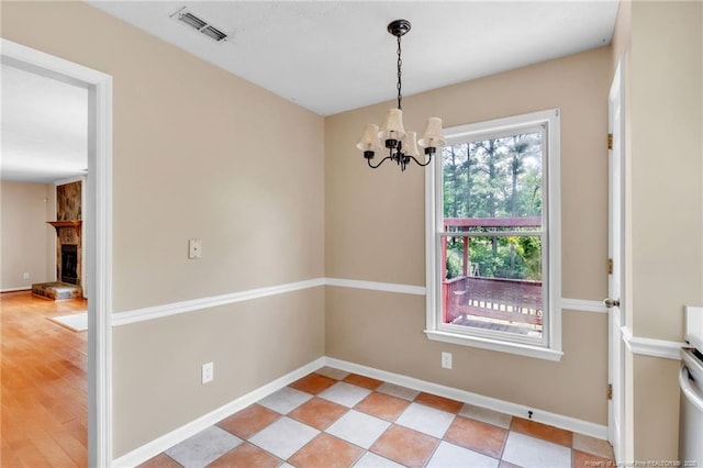 4725 Grandison Ct, Hope Mills, NC 28348 - unfurnished dining area with a chandelier, baseboards, and a fireplace