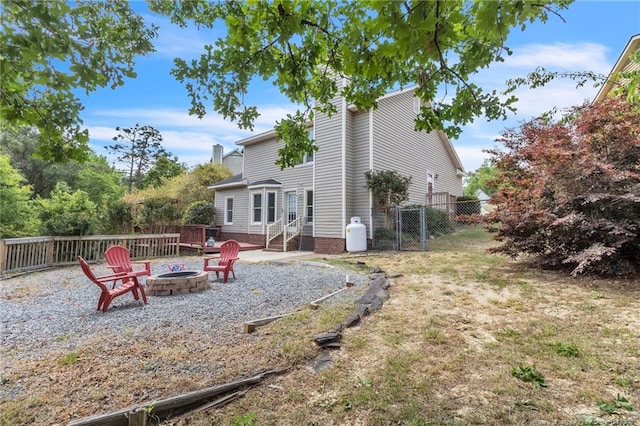4725 Grandison Ct, Hope Mills, NC 28348 - rear view of house with a fire pit, entry steps, a chimney, a gate, and fence
