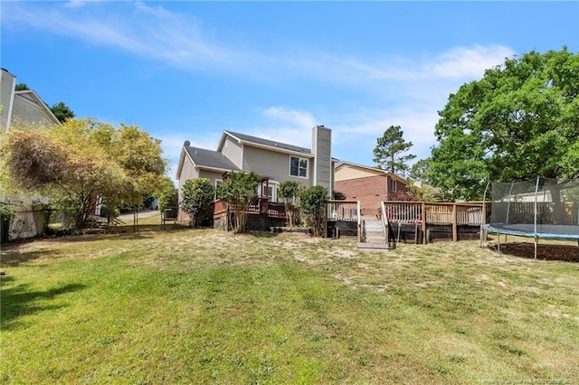 4725 Grandison Ct, Hope Mills, NC 28348 - back of property featuring a trampoline, a wooden deck, and a chimney