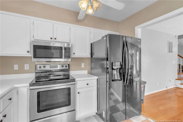 4725 Grandison Ct, Hope Mills, NC 28348 - kitchen featuring stainless steel appliances, white cabinets, light countertops, and a ceiling fan