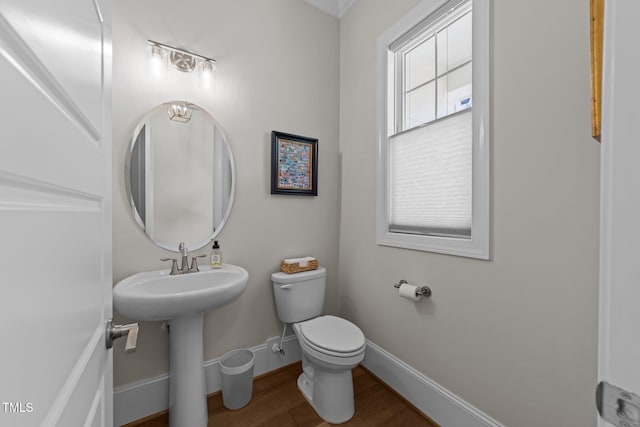 bathroom featuring wood finished floors, toilet, and baseboards