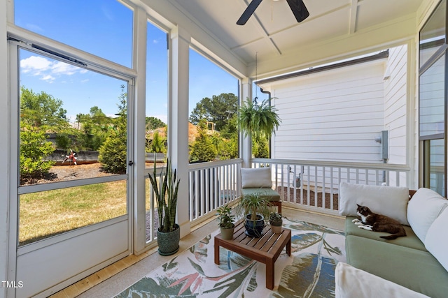 sunroom / solarium with a ceiling fan and healthy amount of natural light