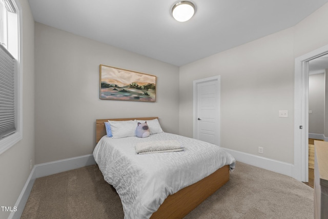 carpeted bedroom with baseboards