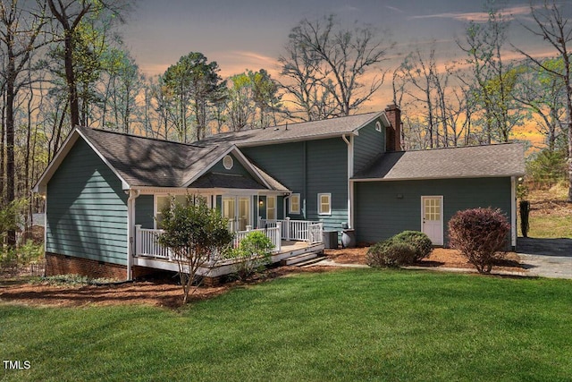 3418 Carriage Trl, Hillsborough, NC 27278 - back of property at dusk with a chimney, a yard, roof with shingles, and covered porch