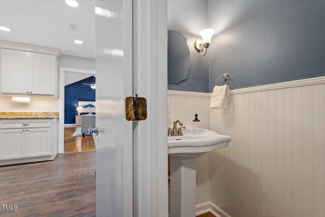 3418 Carriage Trl, Hillsborough, NC 27278 - bathroom with wainscoting, wood finished floors, recessed lighting, a ceiling fan, and a sink