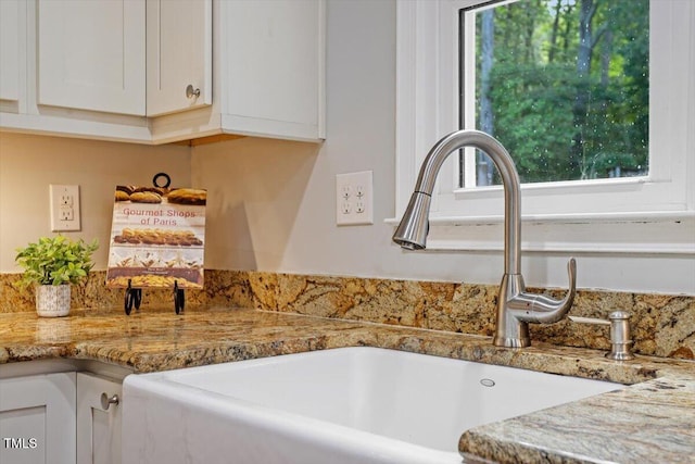 3418 Carriage Trl, Hillsborough, NC 27278 - kitchen view of a sink, white cabinets, and light stone countertops