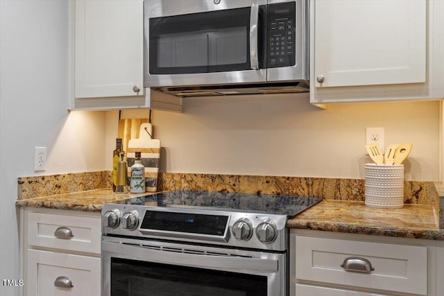 3418 Carriage Trl, Hillsborough, NC 27278 - kitchen with stainless steel appliances, white cabinets, and light stone counters