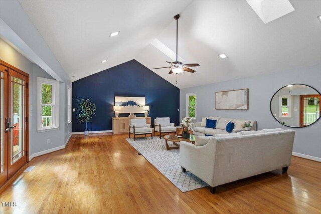 3418 Carriage Trl, Hillsborough, NC 27278 - living area with lofted ceiling, light wood finished floors, a skylight, baseboards, and ceiling fan