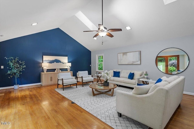 3418 Carriage Trl, Hillsborough, NC 27278 - living area with a ceiling fan, wood finished floors, vaulted ceiling, baseboards, and a skylight