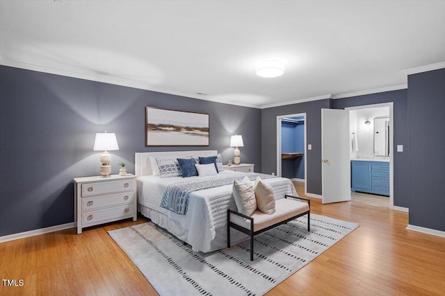 3418 Carriage Trl, Hillsborough, NC 27278 - bedroom with crown molding, light wood finished floors, baseboards, a walk in closet, and ensuite bathroom