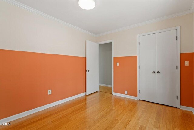 3418 Carriage Trl, Hillsborough, NC 27278 - unfurnished bedroom featuring light wood finished floors, ornamental molding, baseboards, and a closet