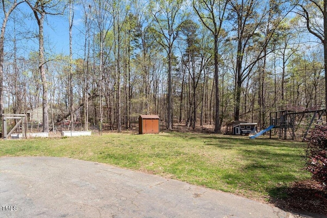 3418 Carriage Trl, Hillsborough, NC 27278 - view of grassy yard featuring a shed, a playground, and an outdoor structure