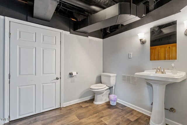 3418 Carriage Trl, Hillsborough, NC 27278 - bathroom featuring toilet, baseboards, wood finished floors, and a sink