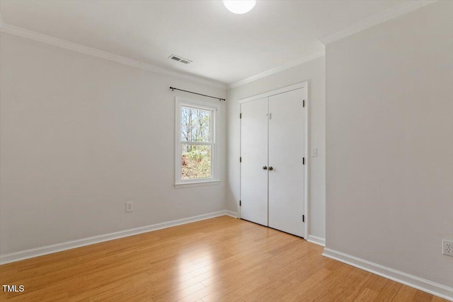 3418 Carriage Trl, Hillsborough, NC 27278 - unfurnished bedroom featuring light wood finished floors, ornamental molding, baseboards, and a closet