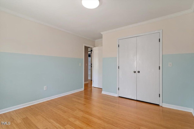 3418 Carriage Trl, Hillsborough, NC 27278 - unfurnished bedroom featuring light wood-style flooring, crown molding, a closet, and baseboards