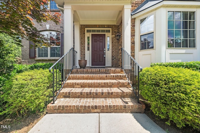 entrance to property with stone siding and brick siding