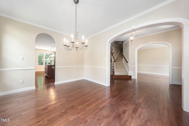 unfurnished room with dark wood-style floors, a chandelier, arched walkways, and crown molding