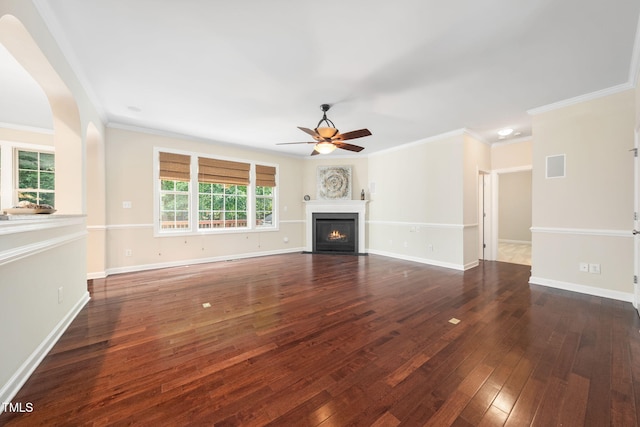 unfurnished living room with a ceiling fan, wood-type flooring, a fireplace with flush hearth, crown molding, and baseboards