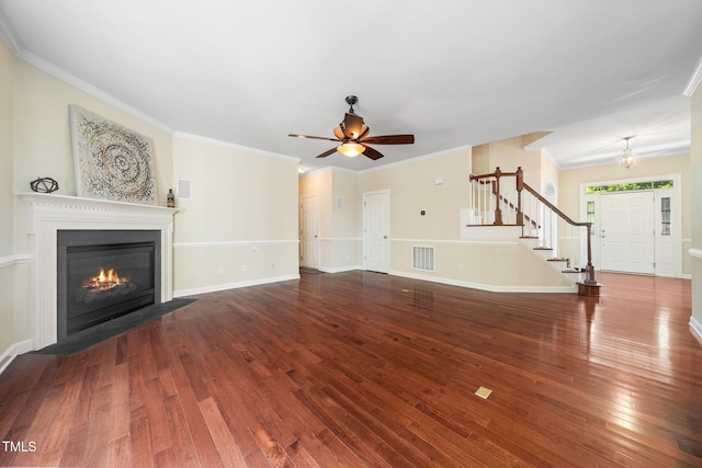 unfurnished living room with stairs, wood finished floors, a ceiling fan, a fireplace with flush hearth, and baseboards