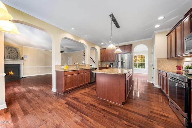 kitchen with stainless steel appliances, decorative backsplash, crown molding, light stone counters, and dark wood-style flooring