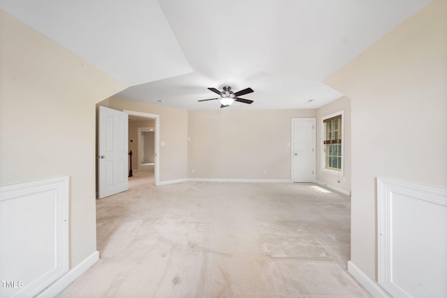 unfurnished room featuring ceiling fan, light colored carpet, and baseboards