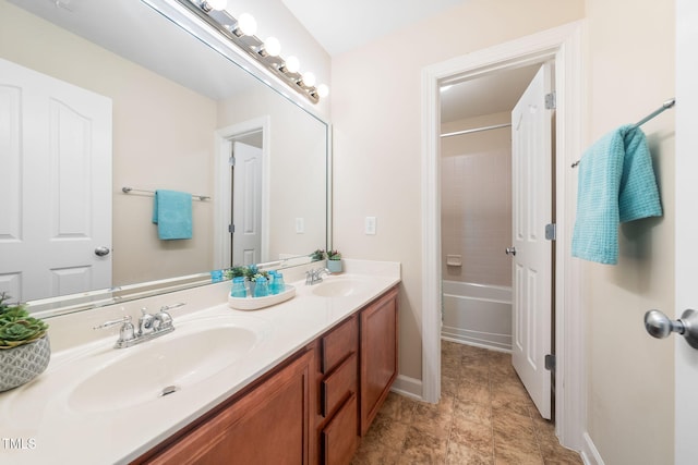 full bath featuring double vanity, baseboards, and tub / shower combination