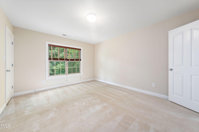 unfurnished bedroom featuring carpet floors and baseboards