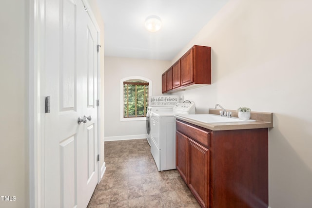 laundry area with washer and dryer, cabinet space, and baseboards