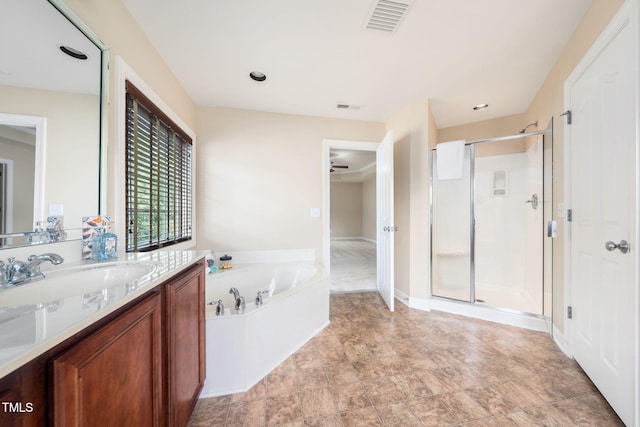 full bath with a shower stall, a bath, a ceiling fan, and vanity