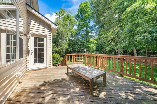 wooden deck featuring view of scattered trees