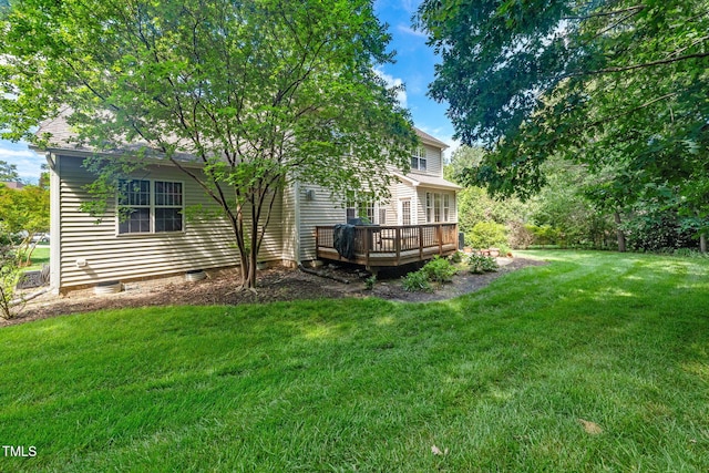 view of grassy yard with a wooden deck